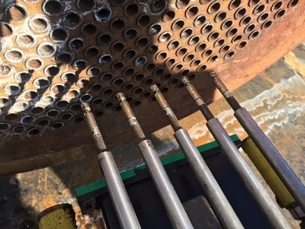 heat exchanger pipe being cleaned by high pressure water jet 