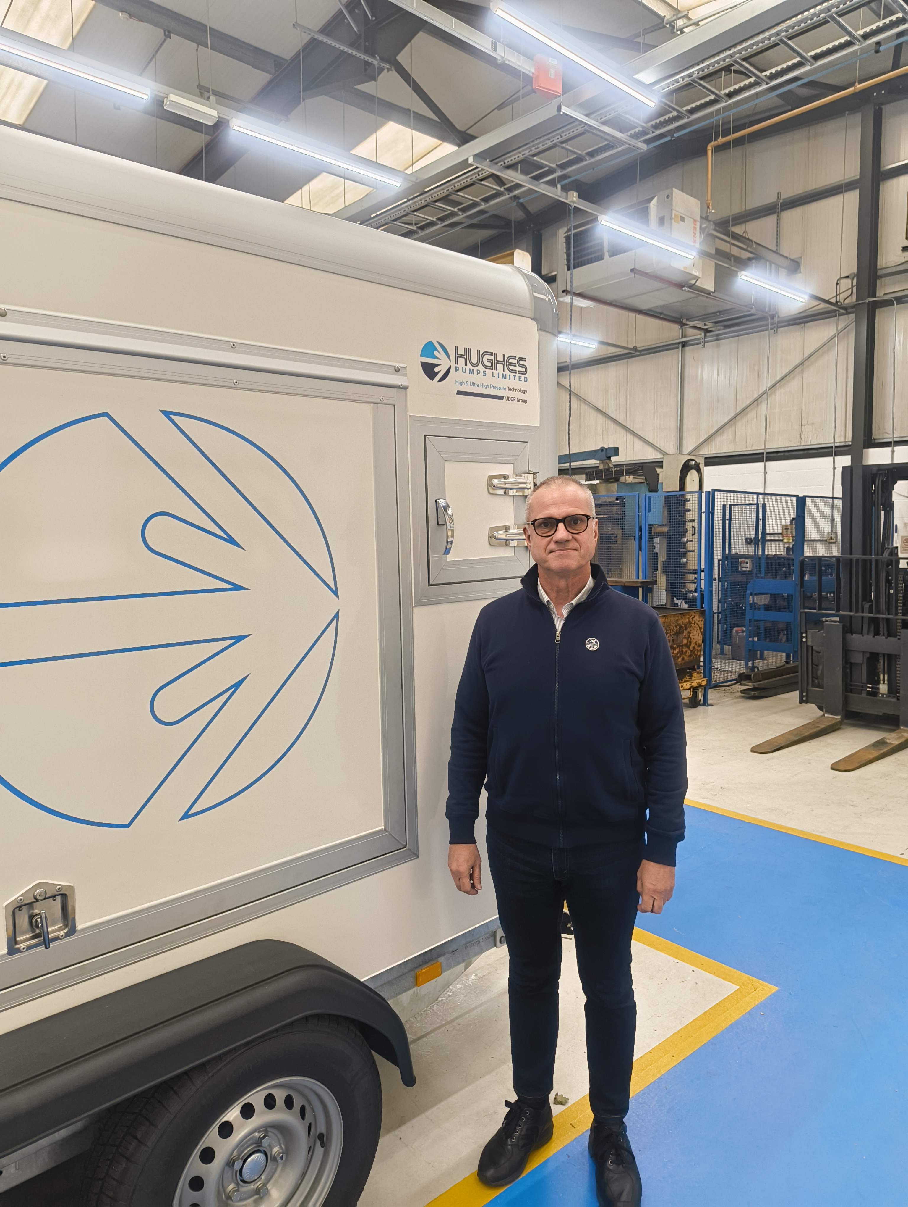 person standing next to uhp water jetting road trailer